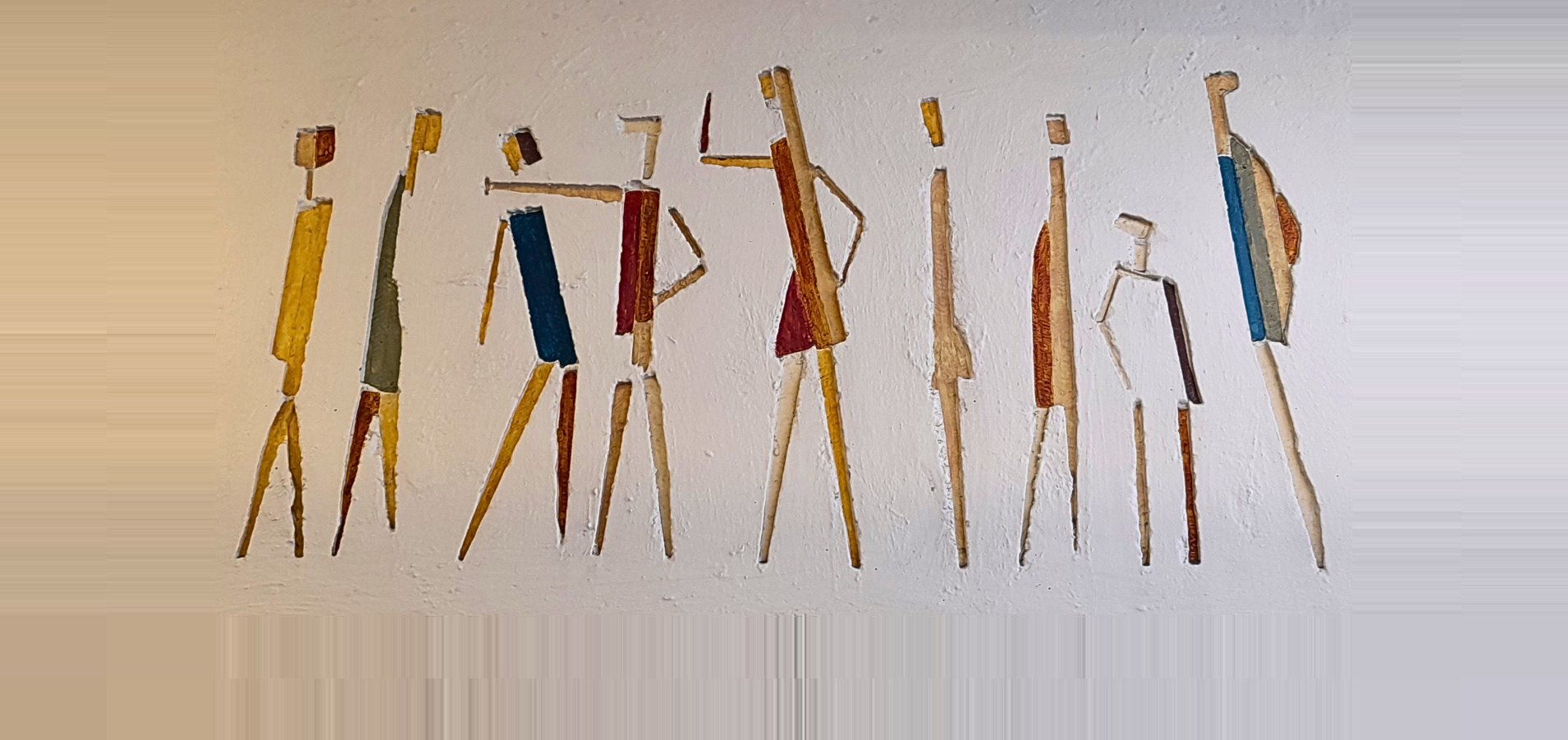 Mural of colourful stick figures carved into a white wall